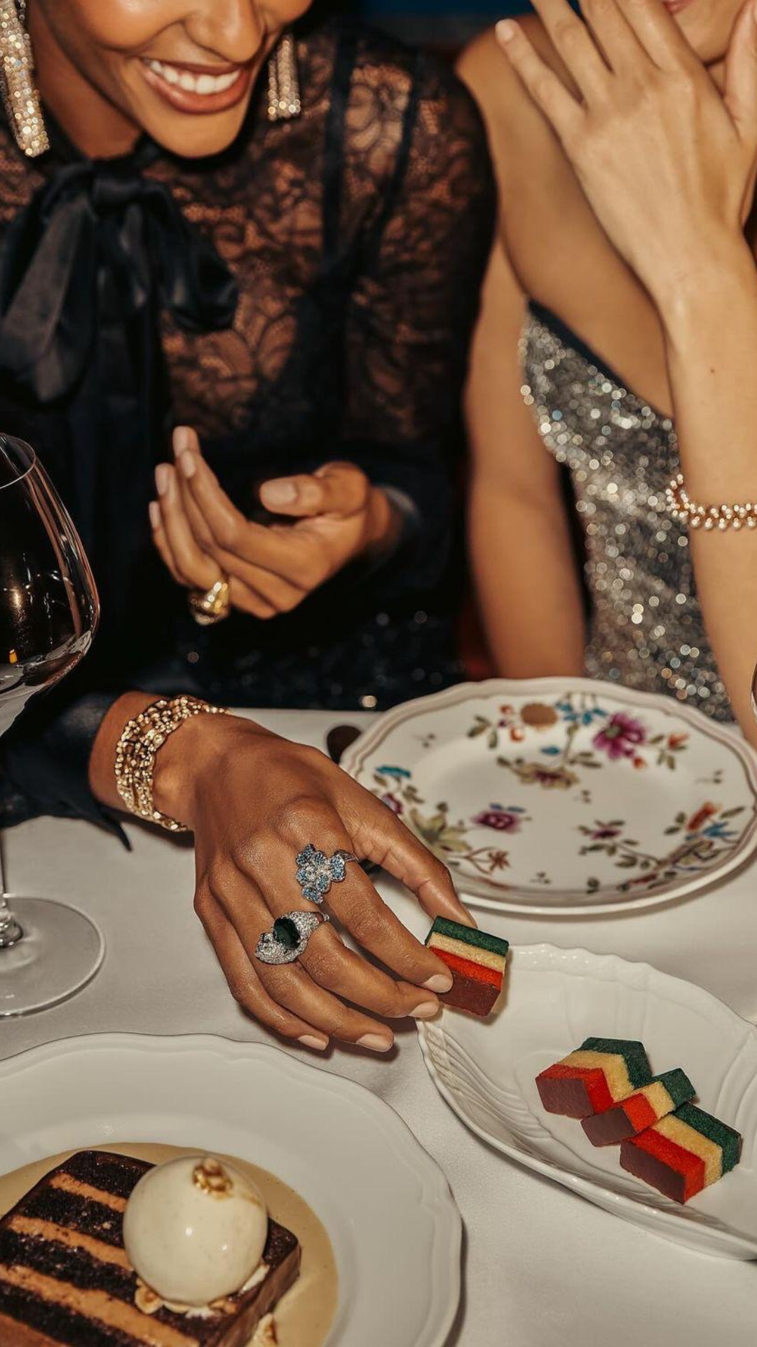 Women sharing a candlelit dessert course at a fine table